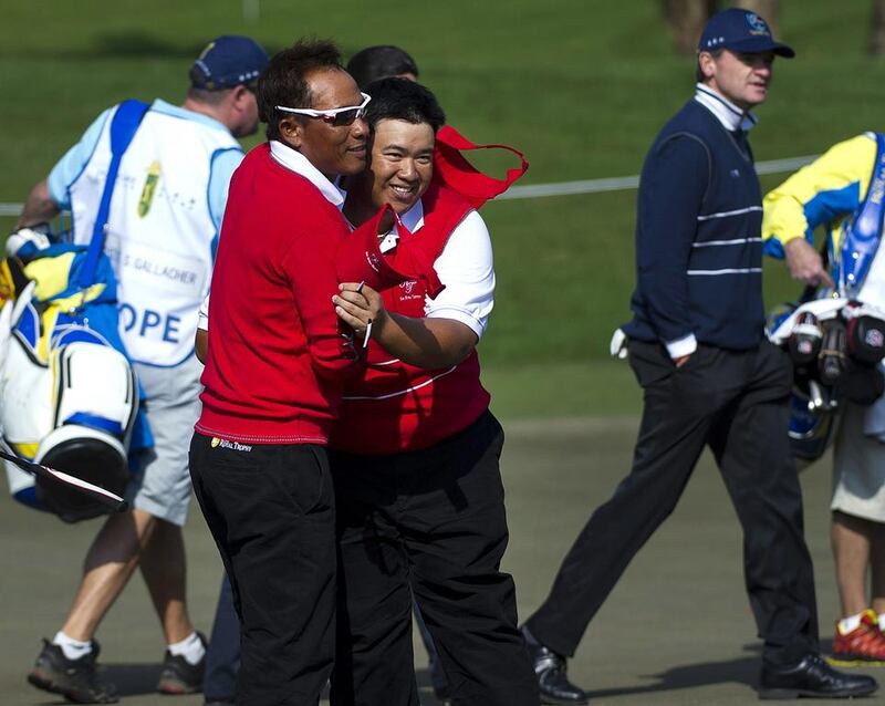 Thailand's Thongchai Jaidee, left, and Kiradech Aphibarnrat celebrate after beating Scotsmen Paul Lawrie and Stephen Gallacher on the first day of the Royal Trophy on Friday. AFP Photo

