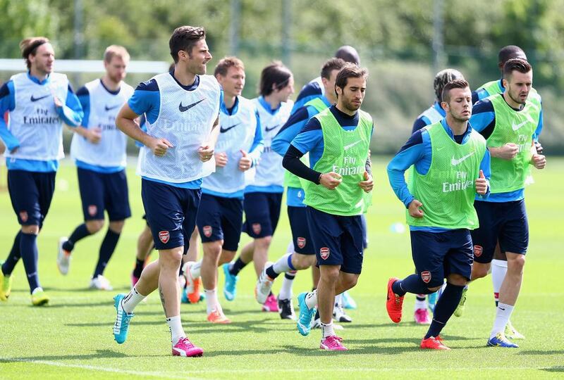 Arsenal players warm up during their training session on Wednesday ahead of Saturday's FA Cup final against Hull City. Clive Mason / Getty Images / May 14, 2014