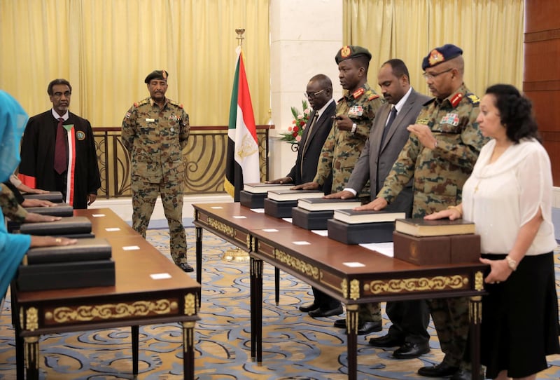 Leader of Sudan's transitional council, Lieutenant General Abdel Fattah Al-Abdelrahman Burhan looks on as military and civilian members of Sudan's new ruling body, the Sovereign Council, are sworn in at the presidential palace in Khartoum, Sudan. Reuters