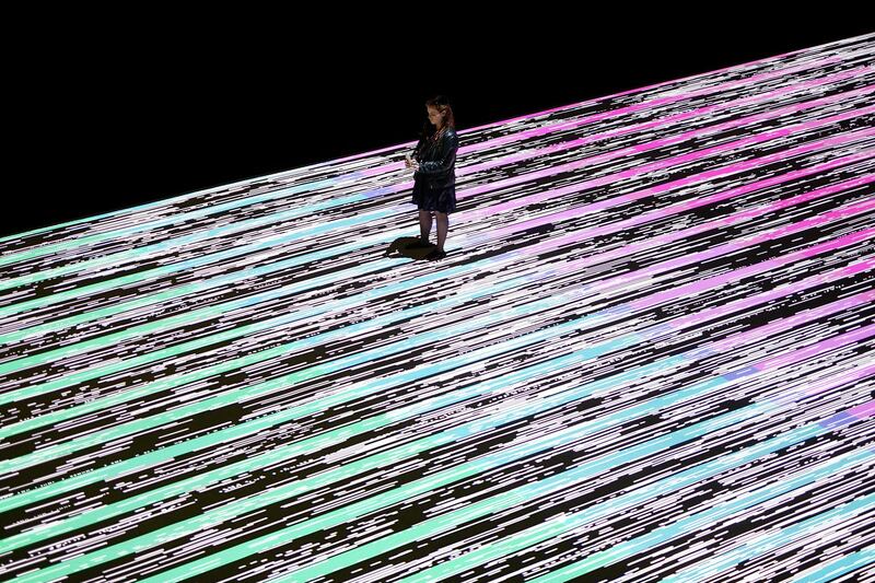 A visitor attends a media preview of the audio-visual installation entitled 'micro / macro' by Japanese visual artist Ryoji Ikeda at Carriageworks in Sydney, Australia. Dan Himbrechts / EPA