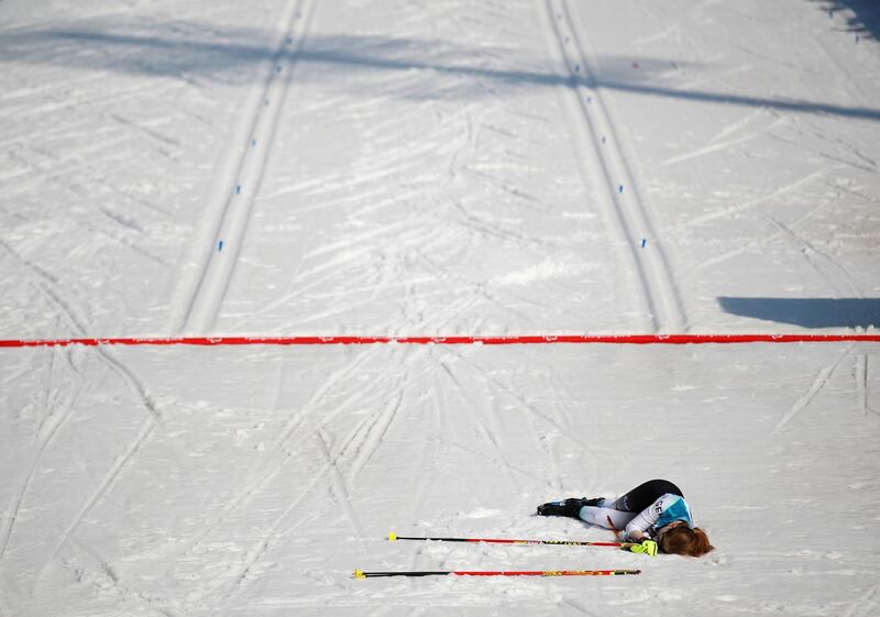 Clara Klug of Germany collapses in the snow after crossing the finish line in third place in the  Pyeongchang 2018 Winter Paralympics - Women's 10km - Visually Impaired. Carl Recine / Reuters