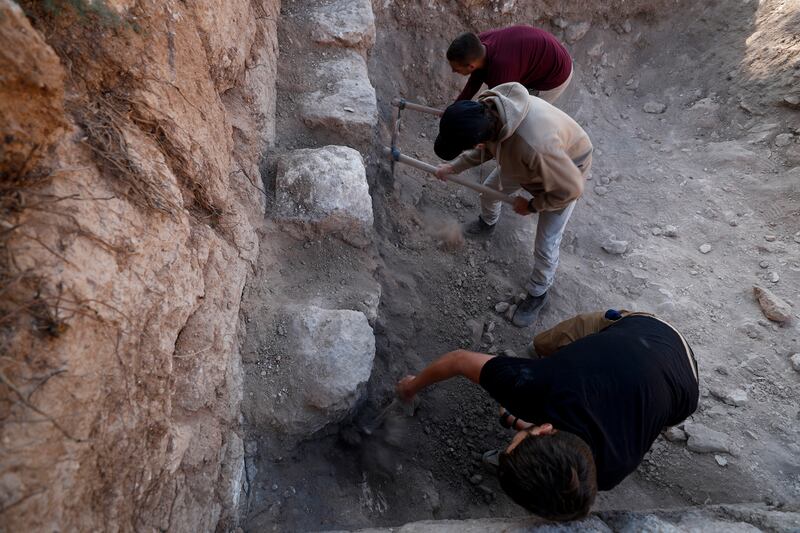 Archaeologists work on the shop stalls that they say sold or rented the lamps. EPA