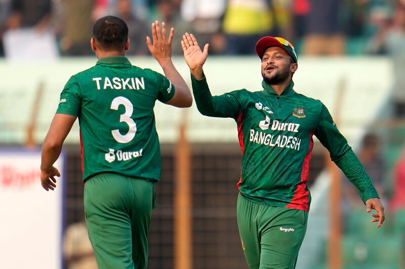 Bangladesh's Taskin Ahmed, left, celebrates with captain Shakib Al Hasan after the dismissal of England batter Chris Woakes for one. AP