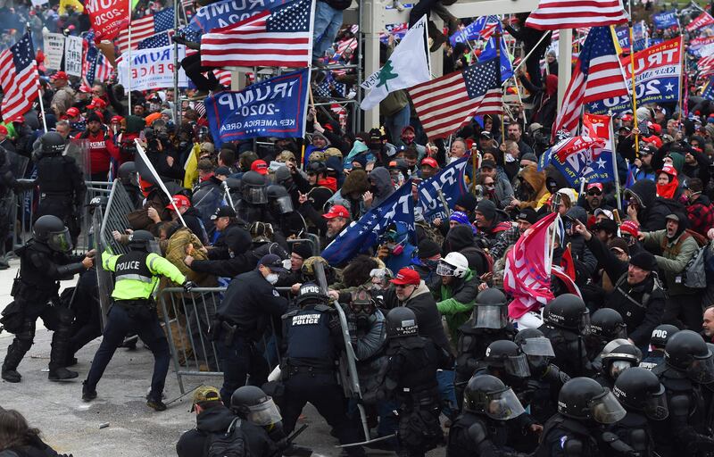 Trump supporters clash with police and security forces as they push barricades to storm the US Capitol in Washington on January 6, 2021. AFP