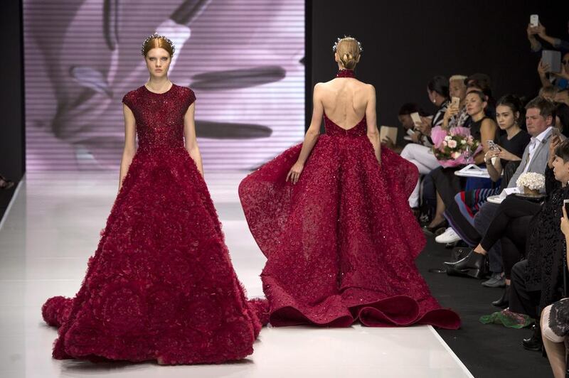 Michael Cinco’s collection included flowing ball gowns in crimson with undulating hems and billowing skirts. Jeremy Lempin / EPA