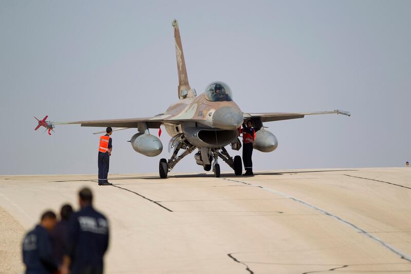 FILE - In this Monday, Nov 25, 2013, file photo, technicians inspect an Israeli air force F-16 jet at the Ovda airbase near Eilat, southern Israel. The Israeli military says it has shot down an Iranian drone that infiltrated the country and has struck Iranian targets in Syria that launched it. The military says that as part of the unusual event one of its F-16 jets crashed in northern Israel. (AP Photo/Ariel Schalit, File)