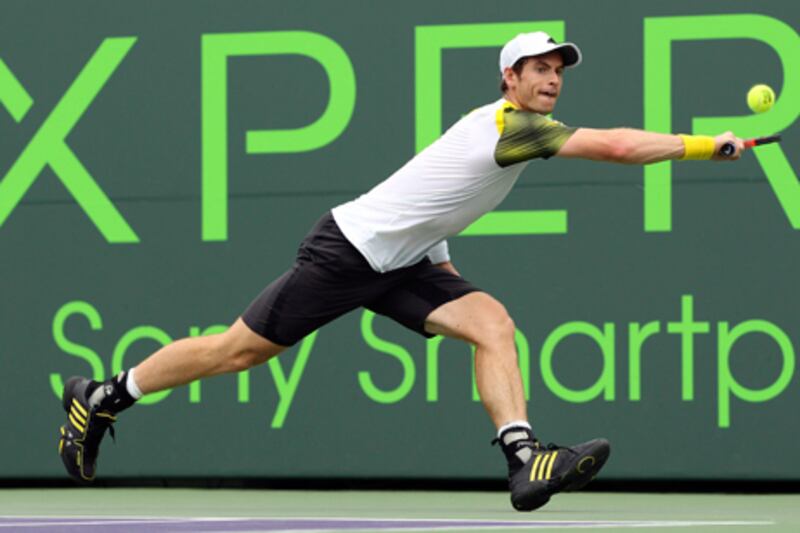 Andy Murray stretches to reach a shot from Grigor Dimitrov.