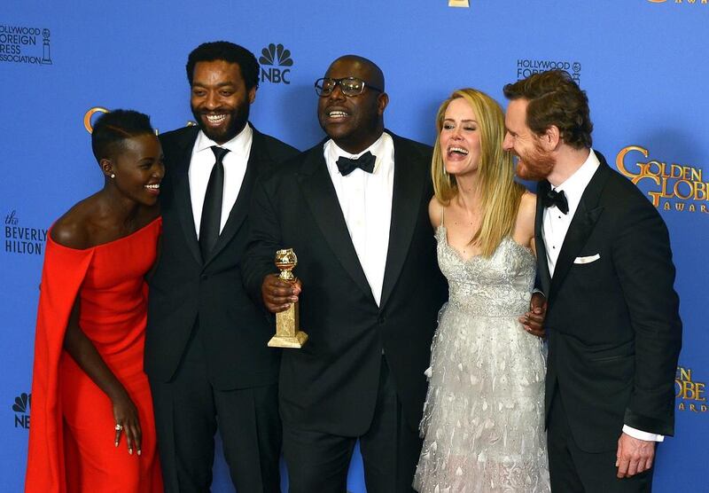 British director Steve McQueen (C) holds the Golden Globe for Best Motion Picture - Drama for '12 Years a Slave' as he poses with actress Lupita Nyong'o, Chiwetel Ejiofor, Sarah Paulson and Michael Fassbender in the press room. EPA 