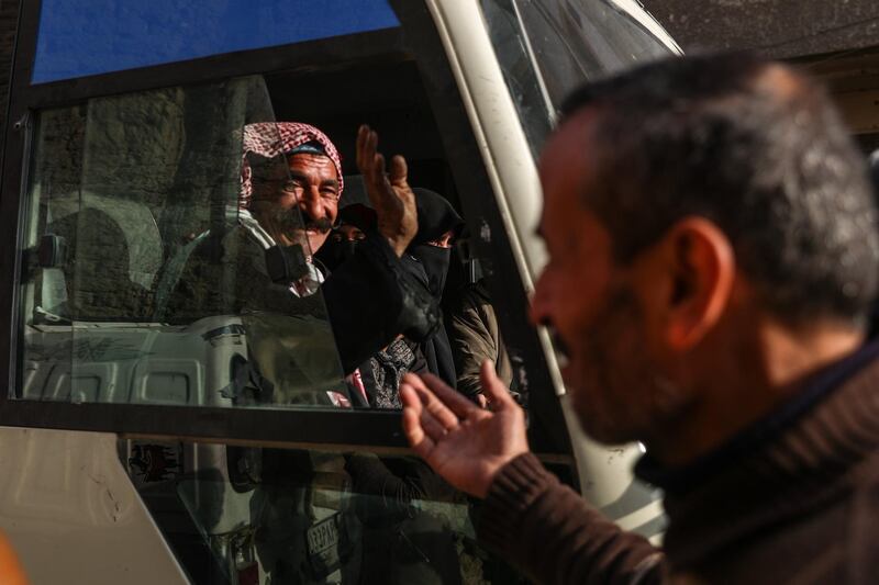 An elderly man waves to relatives from inside a bus during the evacuation in rebel-held Douma, Syria on March 17, 2018. Mohammed Badra / EPA
