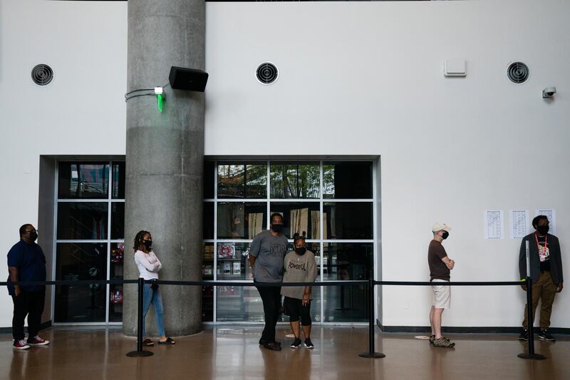 Voters wearing protective masks stand in line to cast ballots at an early voting polling location for the 2020 Presidential elections in Atlanta, Georgia, U.S. Bloomberg