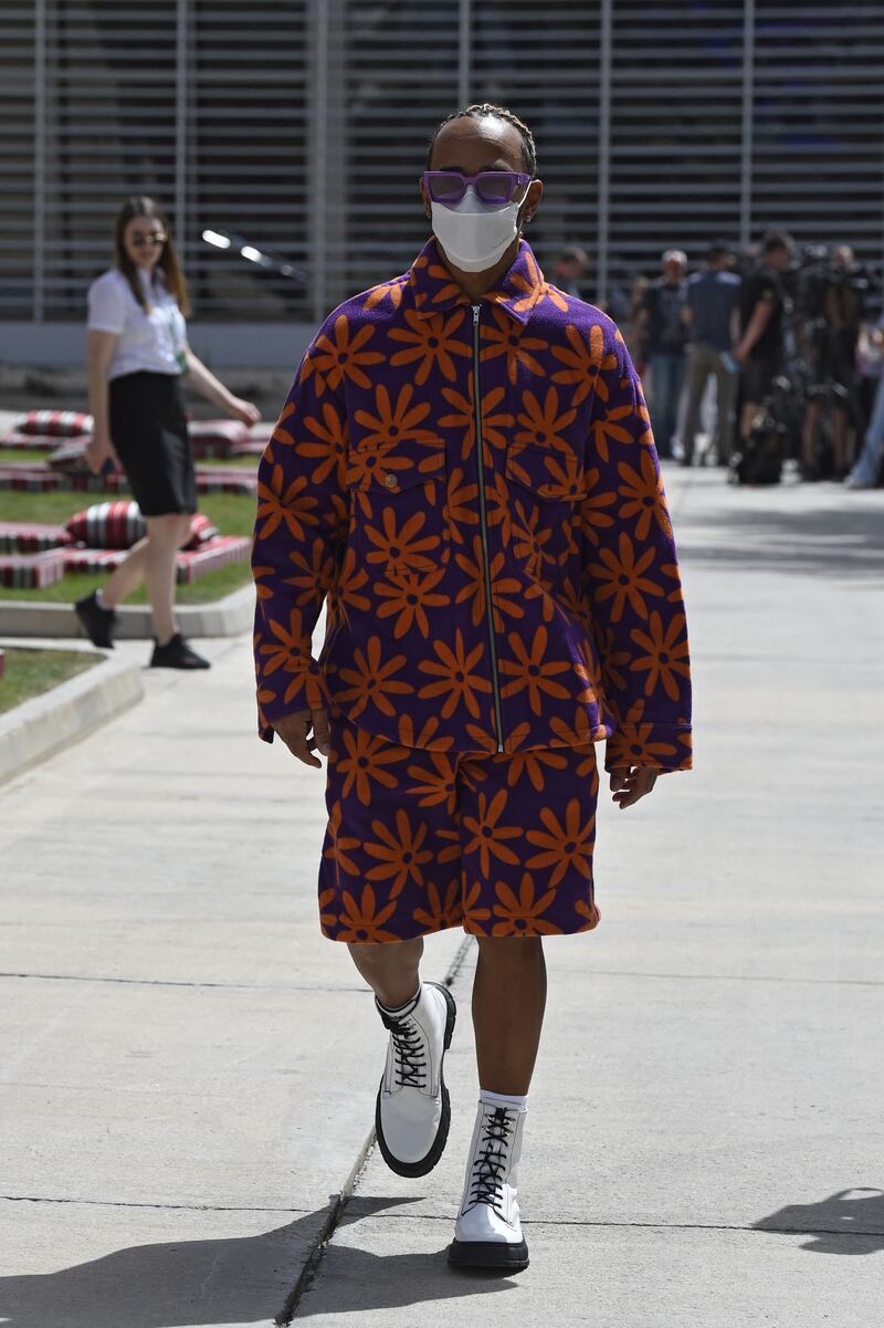 Lewis Hamilton, in a blue and orange floral Jacquemus jacket and shorts set, arrives ahead of the third practice session ahead of the Bahrain Grand Prix at the Bahrain International Circuit on March 19, 2022. AFP 