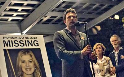 Ben Affleck, and Rosamund Pike (on the poster) in the first photo released by 20th Century Fox for the much anticipated movie, Gone Girl. Dec.29, 2013. At left are Lisa Banes and David Clennon.
CREDIT: Courtesy 20th Century Fox *** Local Caption ***  blog.Gone.Girl.jpg