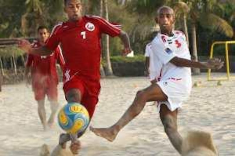 DUBAI-JUNE 17,2009 - Ali Hassan Karim  (3) of UAE team in action against Isaq Almaz (10) of Oman team during Beach soccer freindly game at Al Mamzar beach in Dubai. ( Paulo Vecina/The National ) *** Local Caption ***  PV Beach Soccer 6.jpg