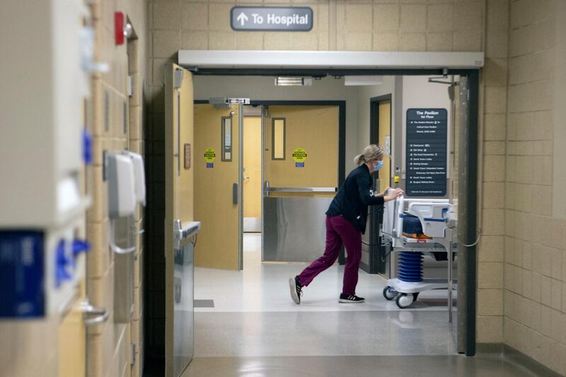 A nurse at Stormont Vail Health System pushes a hospital bed through hallways in Topeka, Kansas. AP