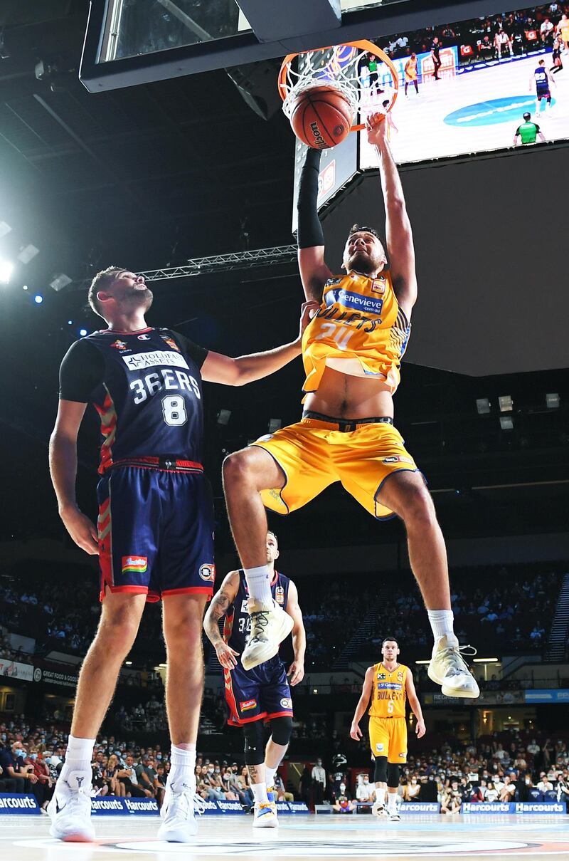 Brisbane Bullets' Tyrell Harrison of the Bullets slam dunks over Issac Humphries of the Adelaide 36ers during the NBL match at Adelaide Entertainment Centre, on Monday, February 15. The Bullets won the match 93-74. Getty