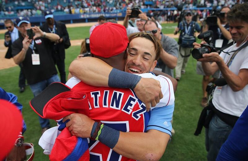 Tampa Bay Rays’ Dayron Varona, who defected from Cuba in 2013, is hugged by members of the Cuban National team after an exposition game at the Estado Latinoamericano in Havana, Cuba. US President Barack Obama attended the game and it is the first time a sittng president has visited Cuba in 88 years.  Joe Raedle / Getty Images