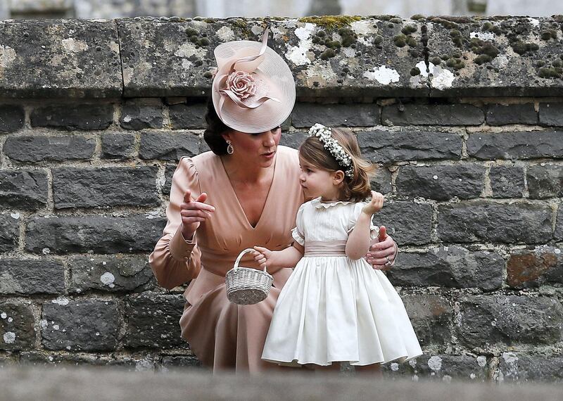 ENGLEFIELD, ENGLAND - MAY 20:  Catherine, Duchess of Cambridge speaks to Princess Charlotte after the wedding of Pippa Middleton and James Matthews at St Mark's Church on May 20, 2017 in in Englefield, England. Middleton, the sister of Catherine, Duchess of Cambridge married hedge fund manager James Matthews in a ceremony Saturday where her niece and nephew Prince George and Princess Charlotte was in the wedding party, along with sister Kate and princes Harry and William. (Photo by Kirsty Wigglesworth - Pool/Getty Images)
