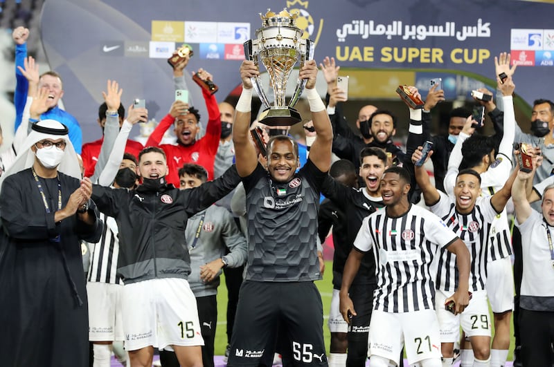 Ali Khaseif lifts the trophy after Al Jazira beat Shabab Al Ahli 5-3 on penalties, to win the UAE Super Cup, in Al Ain on Friday. All photos: Chris Whiteoak/ The National