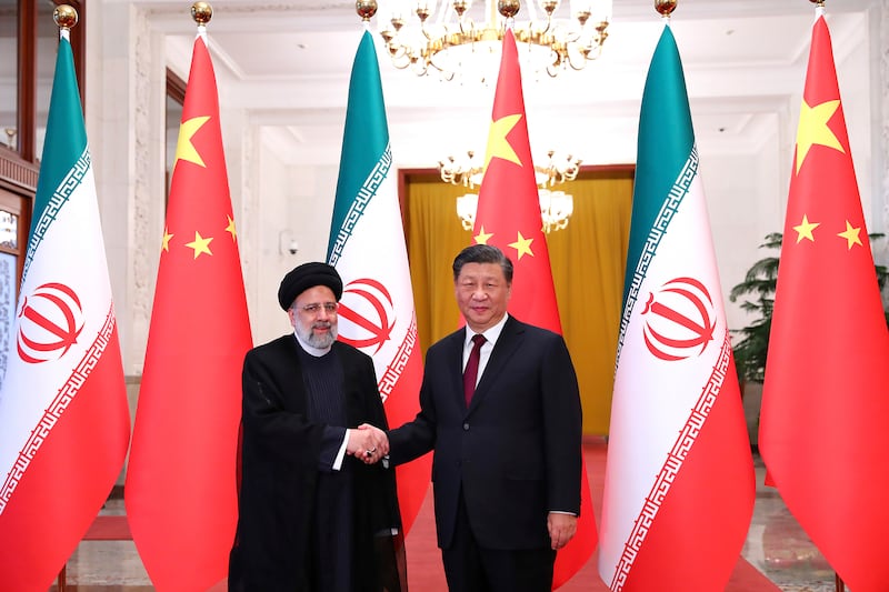 President Ebrahim Raisi, left, shakes hands with his Chinese counterpart Xi Jinping in Beijing. Iranian Presidency Office via AP