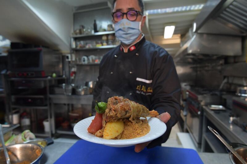 Tunisian chef Taieb Bouhadra presents a traditional Tunisian lamb couscous dish at a restaurant in the Medina of Tunisia's capital, Tunis. AFP