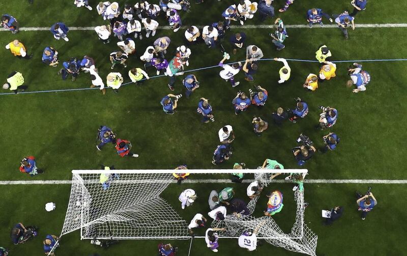 Real Madrid players cut the goal net after winning the Uefa Champions League final. Pawel Kopczynski / Reuters