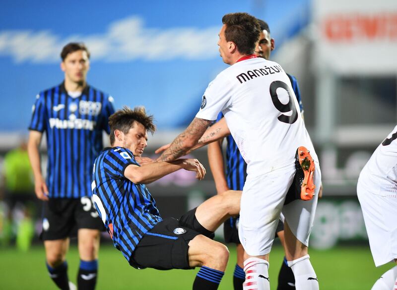 Atalanta's Marten de Roon lands a painful kick on Mario Mandzukic of AC Milan during the Serie A match at Stadio Atleti Azzurri on Sunday, May 23. Reuters