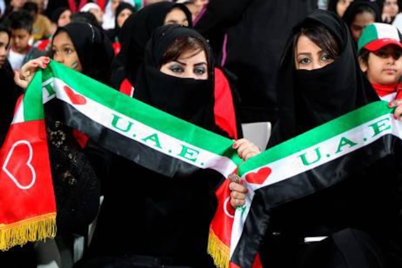 Supporters of the United Arab Emirates (UAE) wave scarfs prior the start of the Gulf Cup's final football match between UAE and Iraq on January 18, 2013 in Manama. Marwan Naamani / AFP