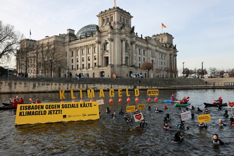 Greenpeace activists protest before the German parliament in Berlin discusses finalising this year’s budget. The message reads ‘Climate money now!’ Reuters