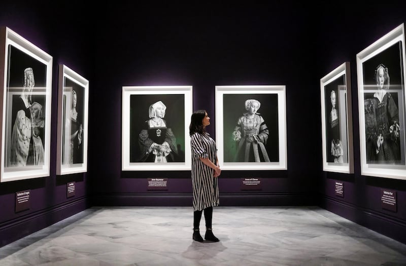 A gallery worker views works from the exhibition Six Lives: The Stories of Henry VIII's Queens which runs at the National Portrait Gallery in London from 20 June until 8 September 2024. EPA
