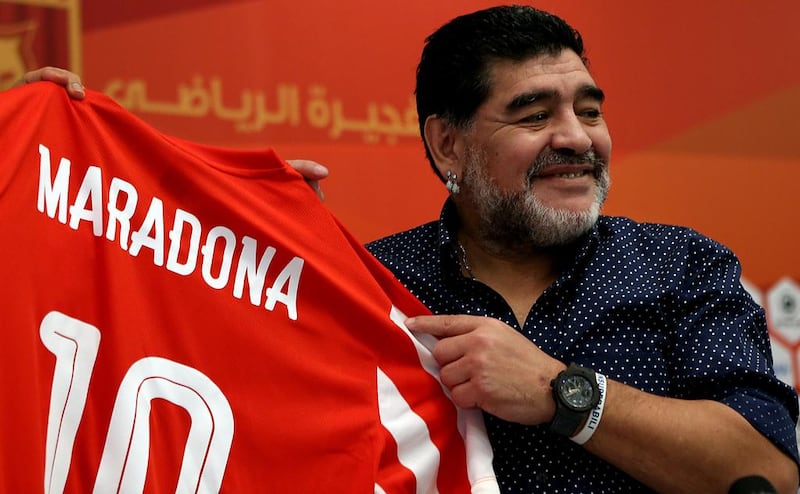 Diego Maradona holds up a Fujairah shirt bearing his name as he was officially introduced to the media as the club's new manager at a press conference in Fujairah on Sunday, May 14, 2017. Satish Kumar / The National