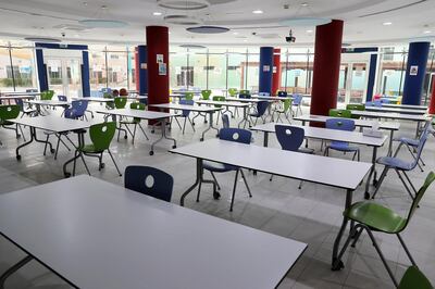 DUBAI, UNITED ARAB EMIRATES , August 9 – 2020 :- View of the canteen area and around 2 meters distance on the sitting table at the Dubai British School in Jumeirah Park in Dubai. New Covid safety setup in different areas of the school such as 1.5 meter distance on the table in the class room, hand sanitizer, safety message, social distancing stickers pasted on the floor, thermal cameras will be installed at the entrance of the school. School will open on 30th August. (Pawan Singh / The National) For News/Online/Instagram. Story by Kelly