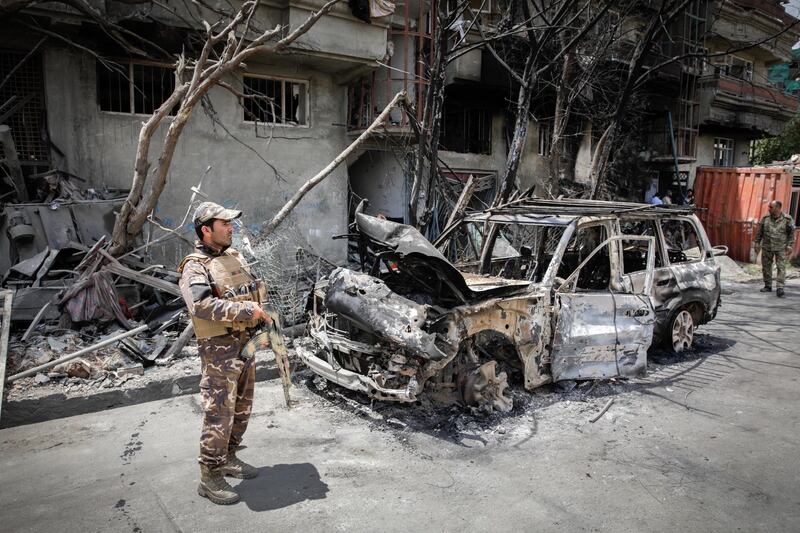epa07747169 An Afghan security officer inspects the scene of the damaged area a day after a suicide attack followed by a gunfight against the office of Afghan former chief of intelligence and current candidate for first vice president of Ashraf Ghani, in Kabul, Afghanistan, 29 July 2019. According to reports, at least 20 people were killed and 50 others wounded in the incident which targeted the office of Amrullah Saleh.  EPA/HEDAYATULLAH AMID