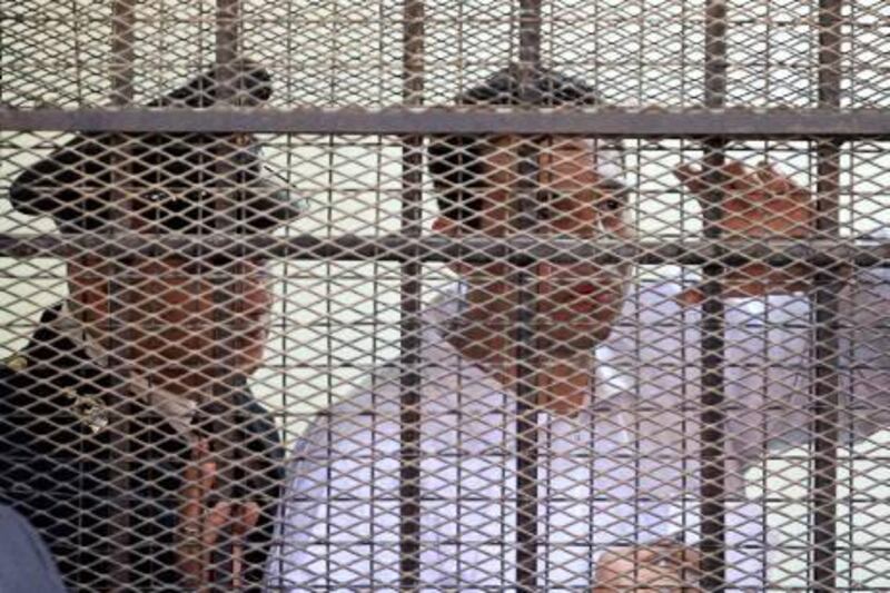 Retired Egyptian policeman Mohsen al-Sukkari (R) addresses the court as he stands behind bars during his trial in the murder of Lebanese singer Suzanne Tamim at a court in Cairo on April 28, 2010. An Egyptian appeal court has ordered the retrial of Sukkari and Egyptian tycoon Hisham Talaat Mustafa, who were convicted and sentenced to death in 2009, for respectively ordering and carrying out Tamim's murder in Dubai in July 2008. AFP PHOTO/KHALED DESOUKI *** Local Caption ***  402831-01-08.jpg