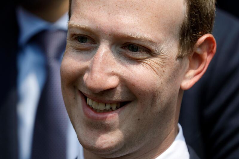 FILE - In this May 23, 2018 file phpoto, Facebook's CEO Mark Zuckerberg smiles during a picture with guests attending the "Tech for Good" Summit at the Elysee Palace in Paris. Zuckerbergâ€™s latest attempt to explain Facebookâ€™s data-sharing practices is notable for its omissions as well as what it plays up and plays down. In a Wall Street Journal op-ed Thursday, Jan. 24, 2019, titled â€œThe Facts About Facebook,â€ the CEO doubles down on previous talking points while leaving out, for example, a Federal Trade Commission investigation over its privacy practices.  (Charles Platiau/Pool Photo via AP, File)
