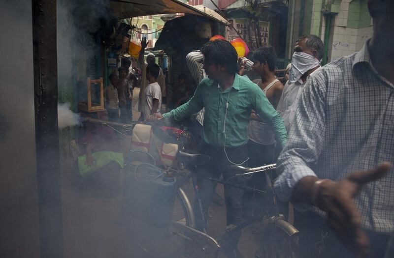 A municipality worker uses a machine to fog for mosquitoes at a neighbourhood in New Delhi, India. Despite efforts to stop mosquitoes from spreading dengue fever in New Delhi have failed to keep the city from its biggest outbreak in almost two decades: more than 10,190 registered cases, including 32 deaths. Saurabh Das/AP Photo