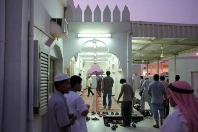 August 16. Worshippers enter the Sheikha Jaziah al Subah mosque in the old part of Ras Al Khaimah city. August 16, 2011. Ras Al Khaimah, United Arab Emirates. (Photo: Antonie Robertso/The National)