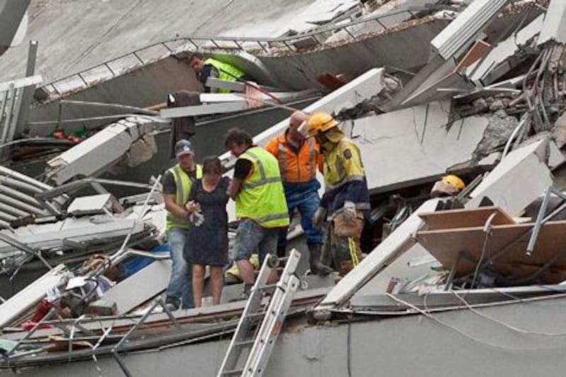 Rescue workers pull people out of a building damaged by Tuesday's earthquake in Christchurch February 23, 2011. New Zealand rescuers pulled survivors out of rubble on Wednesday 24 hours after a devastating earthquake in Christchurch as the death toll climbed to 75, with many dozens still trapped inside collapsed buildings.     REUTERS/Christchurch Press/Carys Monteath (NEW ZEALAND - Tags: DISASTER ENVIRONMENT) NO SALES. NO ARCHIVES. FOR EDITORIAL USE ONLY. NOT FOR SALE FOR MARKETING OR ADVERTISING CAMPAIGNS. THIS IMAGE HAS BEEN SUPPLIED BY A THIRD PARTY. IT IS DISTRIBUTED, EXACTLY AS RECEIVED BY REUTERS, AS A SERVICE TO CLIENTS. AUSTRALIA OUT. NO COMMERCIAL OR EDITORIAL SALES IN AUSTRALIA. NEW ZEALAND OUT. NO COMMERCIAL OR EDITORIAL SALES IN NEW ZEALAND