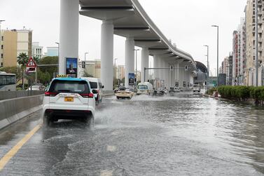 Traffic on the water logged road around Discovery Gardens and Al Furjan area in Dubai. Pawan Singh / The National