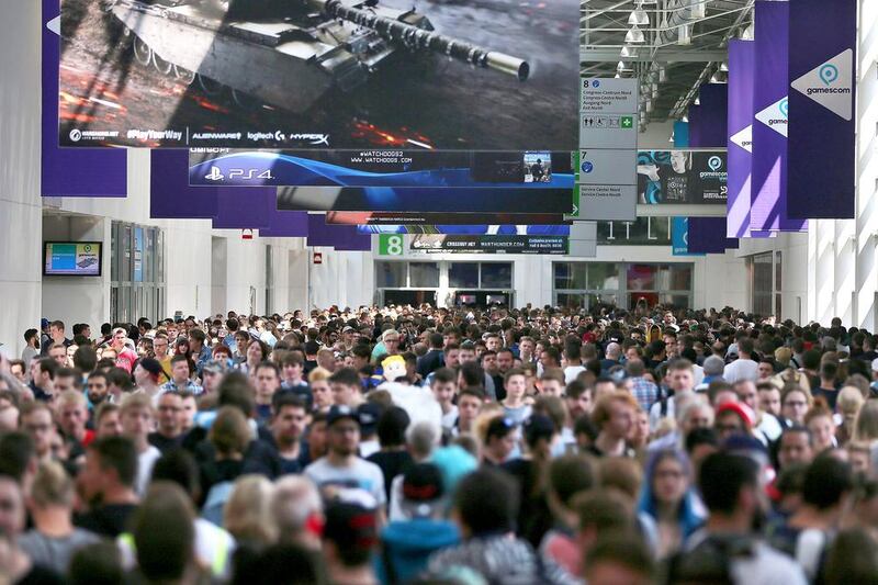 Visitors attend the Gamescom gaming convention in Cologne, Germany. Oliver Berg / EPA