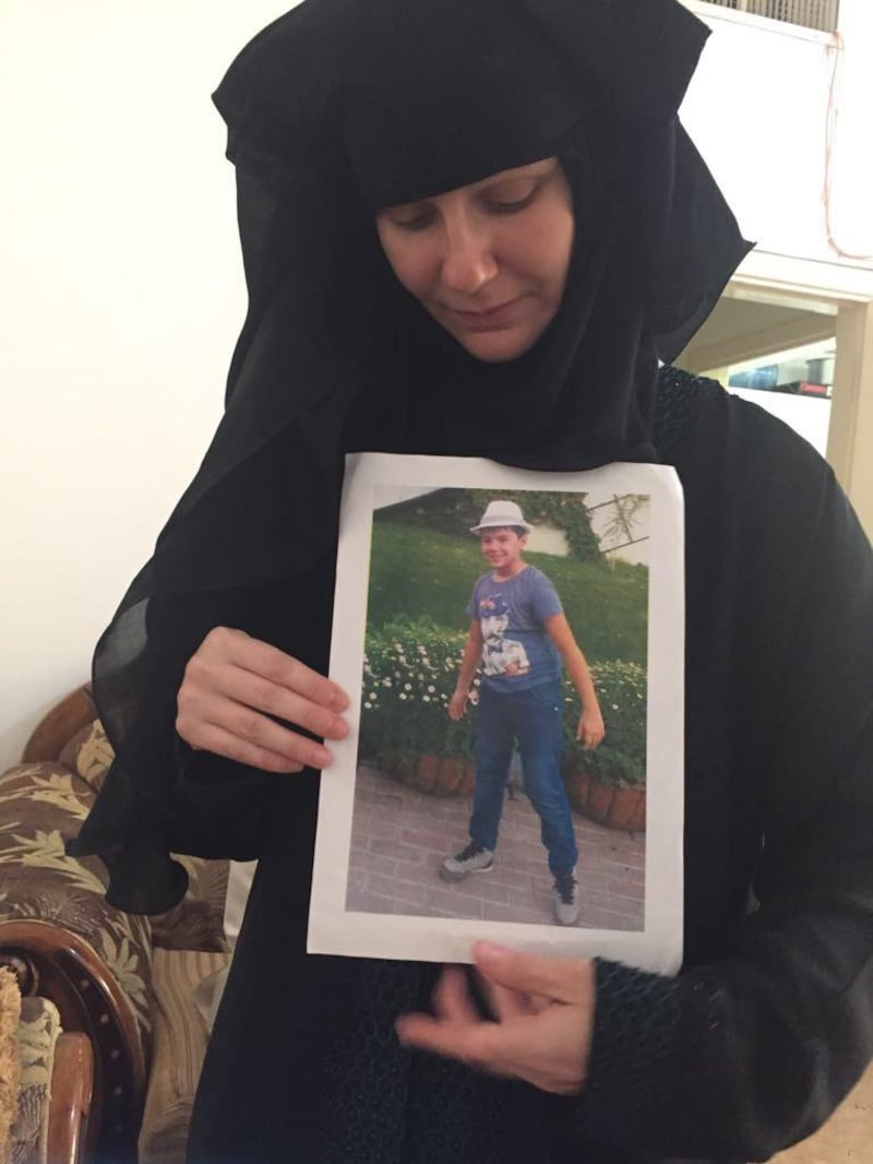Mother of the victim Tatiana kruzina holds a picture of her son. In the background father of the boy Majid janjua (father not pictured here). Photo by Haneen Dajani  *** Local Caption ***  na06ju-mp5-murder-alt3.jpg