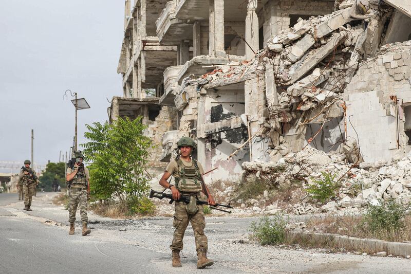 Turkish soldiers patrol on Arbaeen hill overlooking Ariha in the southern countryside of Idlib province, Syria.