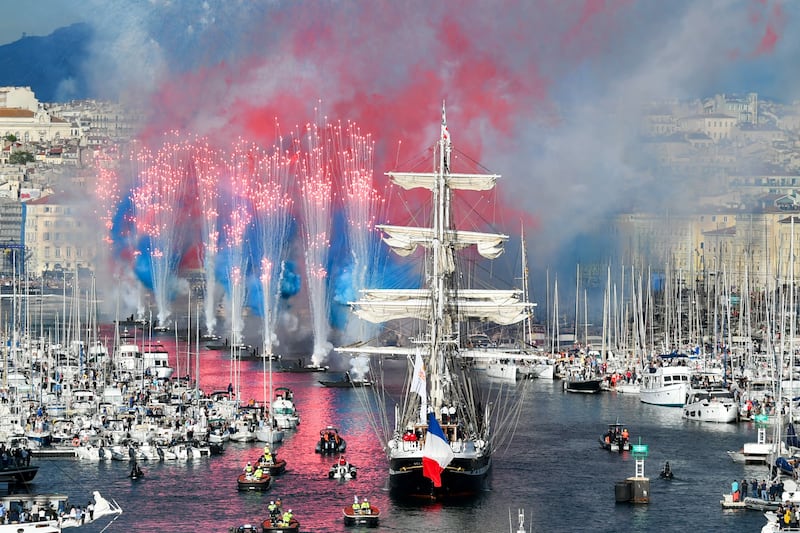 Fireworks follow in the wake of the French 19th century barque Belem as it arrives in the Old Port of Marseille with the Olympic Flame. AFP