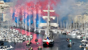 Fireworks go off as the French 19th-century three-masted barque Belem (C) arrives at the Vieux-Port (Old Port) during the Olympic Flame arrival ceremony, ahead of the Paris 2024 Olympic and Paralympic Games, in Marseille, France, on May 8, 2024. AFP