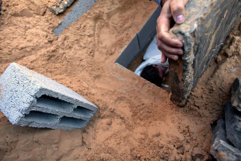 A cement slab is placed over the grave  of Palestinian child  Mohamed Hijazi, grave at the cemetery in  Beit Lahiya , Gaza November 20,2012 . He was named after the family's son Mohamed who was killed in 2008 in the Israel Gaza war in an attack nearby his home by an Israeli drone .
An explosive device hit the family's home November 19,2012 seriously wounding his  mother and killing the father and two children . Other simblings were wounded but survived . (Photo by Heidi Levine/Sipa Press for The National)