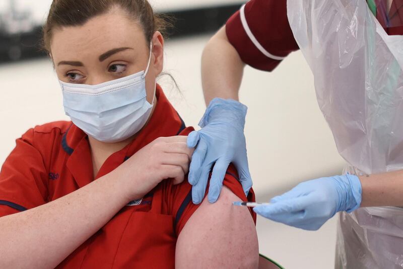 Sister Joanna Sloan receives the Pfizer-BioNTech Covid-19 vaccine, as the first person in Northern Ireland at the Royal Victoria Hospital, in Belfast. AP Photo