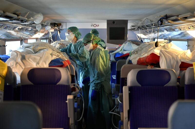 French nurses take care of four patients infected with the novel coronavirus (COVID-19) in a medicalised TGV (high-speed train) at Nancy train station as 24 patients from Nancy and Metz are being transfered from Nancy and Metz towards Bordeaux, Libourne, Pau and Bayonne.  AFP