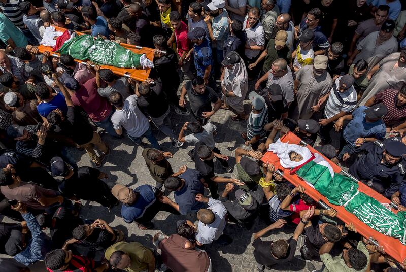 Palestinians carry the bodies of Yasser Al Nabhin and his three children at Al Bureije refugee camp in the central Gaza Strip. EPA