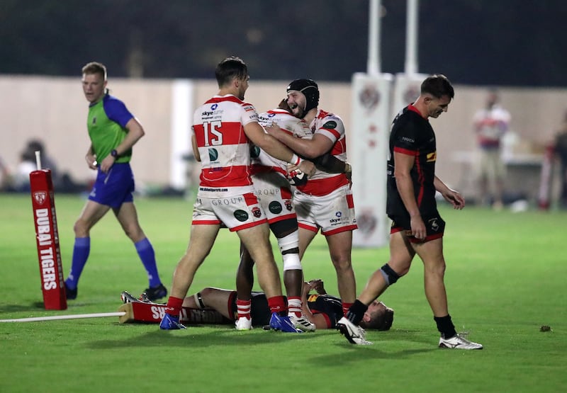 Tigers' Nick Cliffe celebrates with teammates after scoring a try against Bahrain. 
