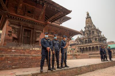 epa09102842 Nepalese police stands guard at Patan Durbar Square during celebrations of Holi Festival amidst Coronavirus restrictions in Kathmandu, Nepal, 28 March 2021. Holi, also known as the Festival of Colors, marks the beginning of spring and is celebrated all over Nepal and neighboring India. Nepal government restricted to celebrate the Holi festival by gathering crowd and organizing party due to the spread of the coronavirus COVID-19 disease.  EPA/NARENDRA SHRESTHA