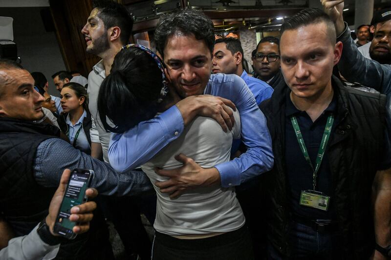 Mayor of Medellin Daniel Quintero hugs a supporter of Mr Petro  after the election. AFP